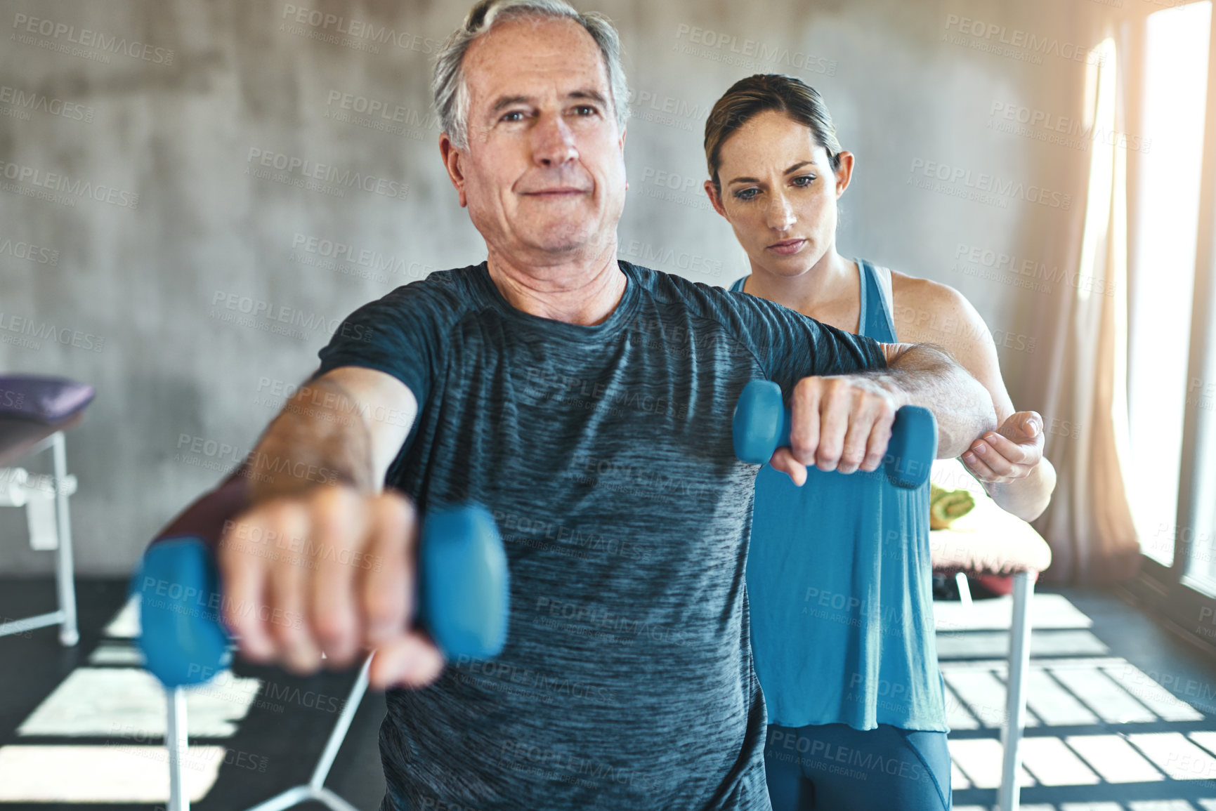 Buy stock photo Physical therapy, dumbbell and support with old man and personal trainer for fitness, health and physiotherapy. Training, weightlifting and coaching with senior patient and physiotherapist for help