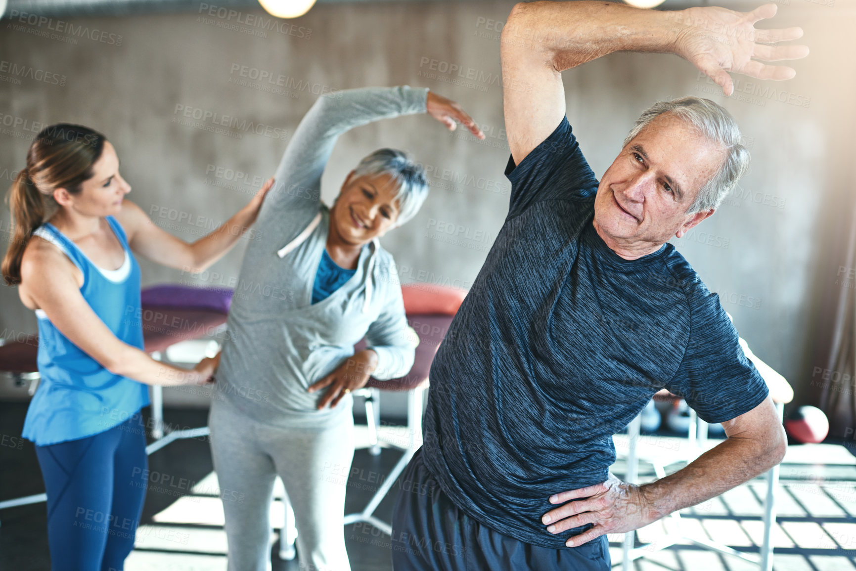 Buy stock photo Stretching, support and senior people in physical therapy for help with muscle fitness and wellness by physiotherapist. Exercise, workout and recovery in hip and spine of mature clients in class