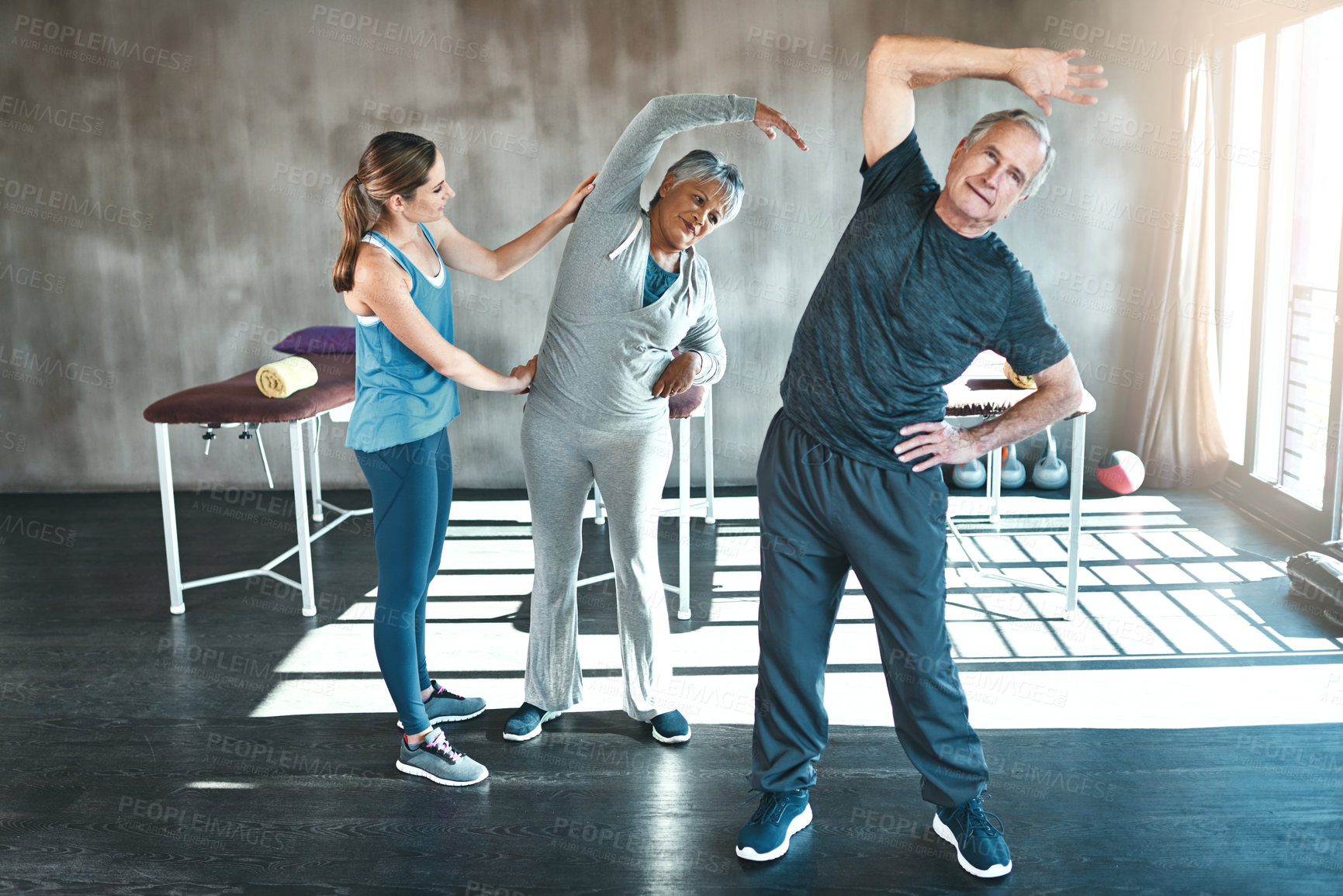 Buy stock photo Stretching, physiotherapy and old couple with personal trainer for fitness, wellness and helping. Health, workout and retirement with senior patient and physiotherapist in class for warm up training