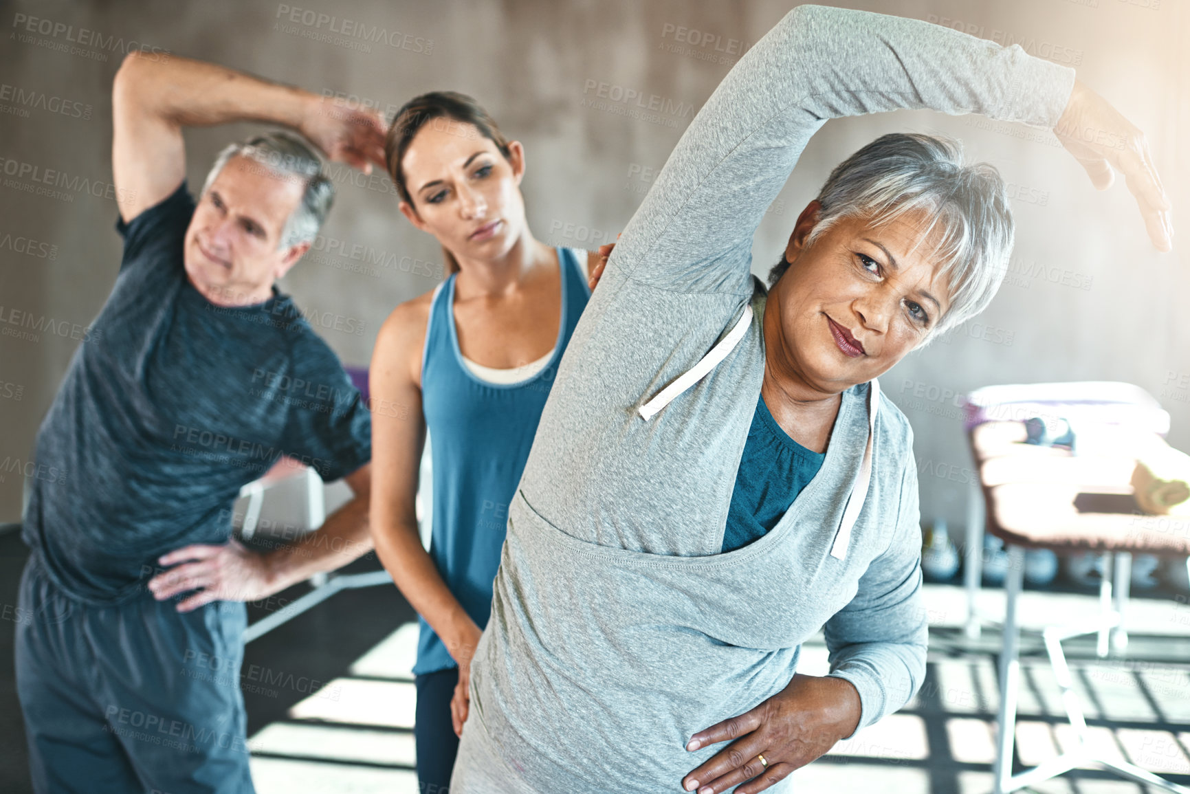 Buy stock photo Stretching, physical therapy and old woman with personal trainer in class for fitness, wellness or rehabilitation. Health, workout or retirement with senior patient and physiotherapist for warm up