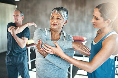 Buy stock photo Stretching, physiotherapy and old woman with personal trainer for fitness, wellness or rehabilitation. Health, workout or retirement with senior patient and female trainer in gym for warm up training