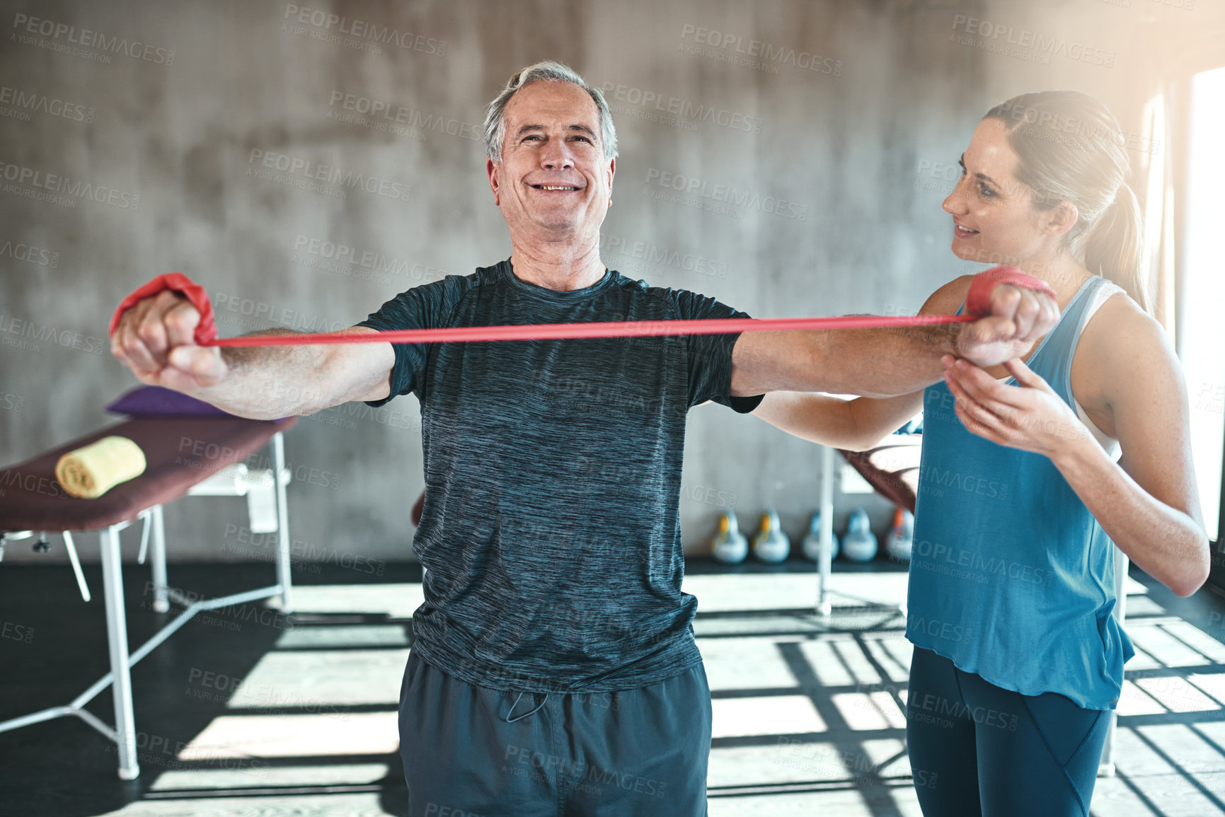 Buy stock photo Physiotherapy, stretching and mature man with resistance band for training, exercise or workout. Physical therapy, gym and physiotherapist with equipment for person for wellness, health or wellbeing