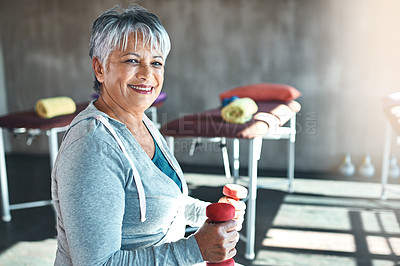 Buy stock photo Portrait of a happy senior woman working out with weights