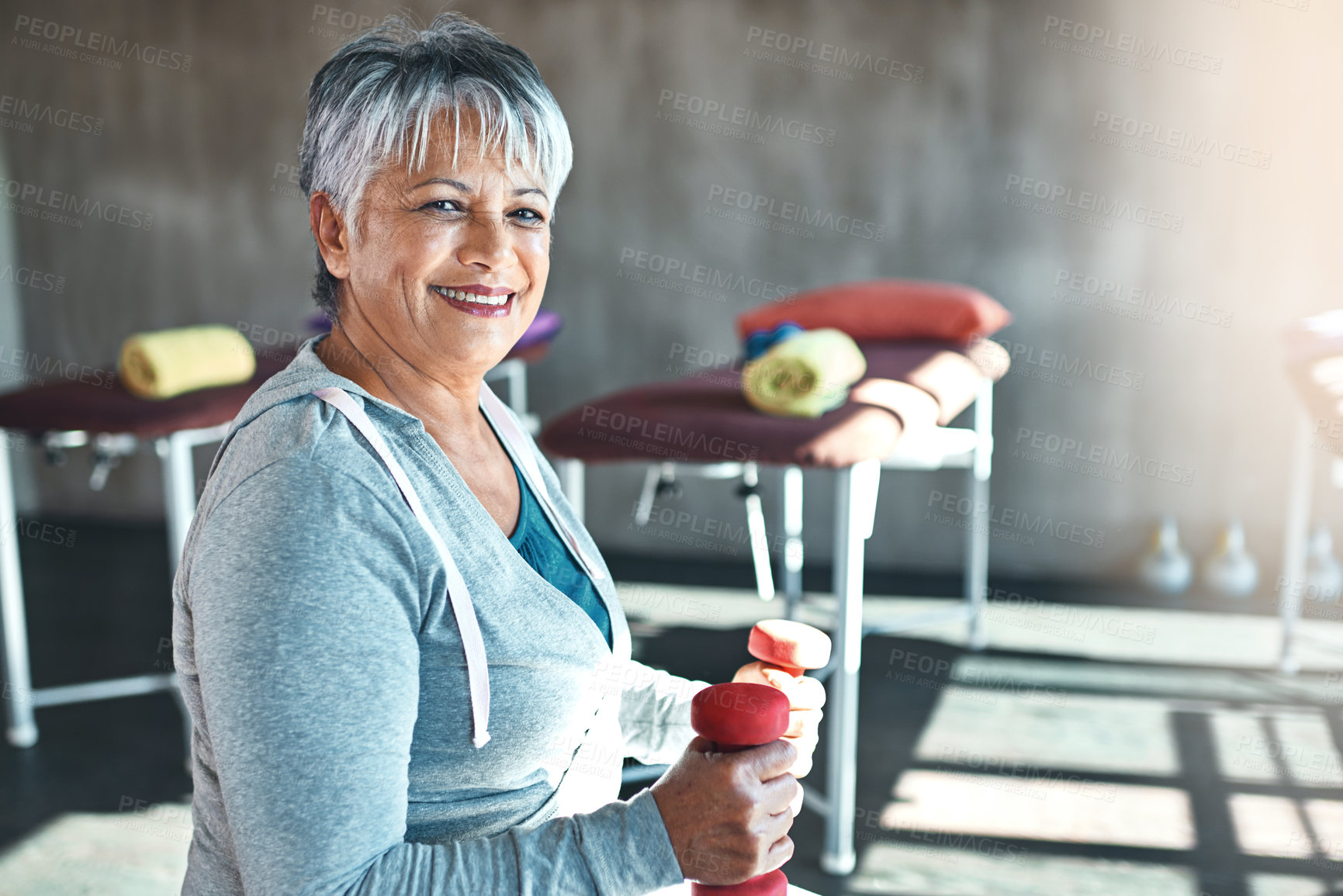 Buy stock photo Portrait of a happy senior woman working out with weights