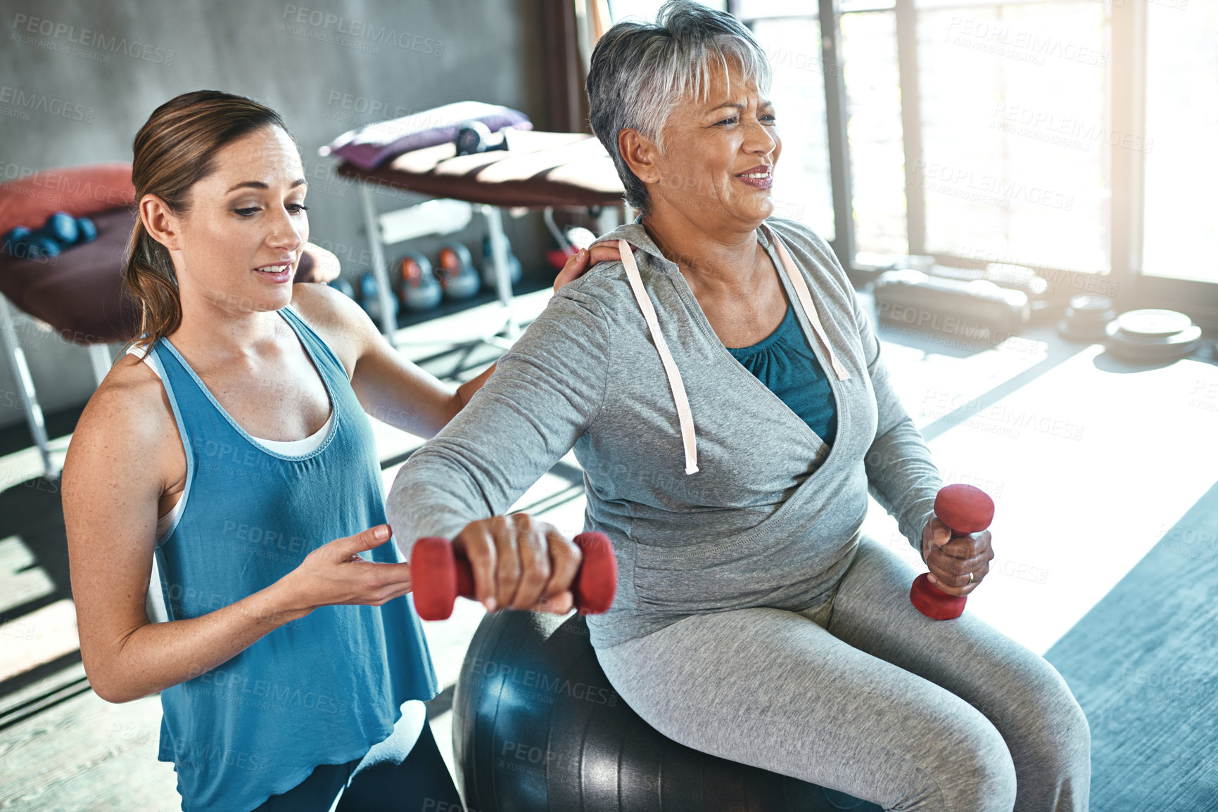 Buy stock photo Old woman, physiotherapy and dumbbell exercise or arm rehabilitation for injury training, joint pain or inflammation. Senior person, arthritis and muscle mobility on fitness ball, recovery or workout