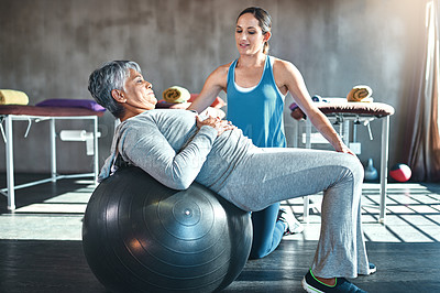 Buy stock photo Shot of a senior woman working out with her physiotherapist
