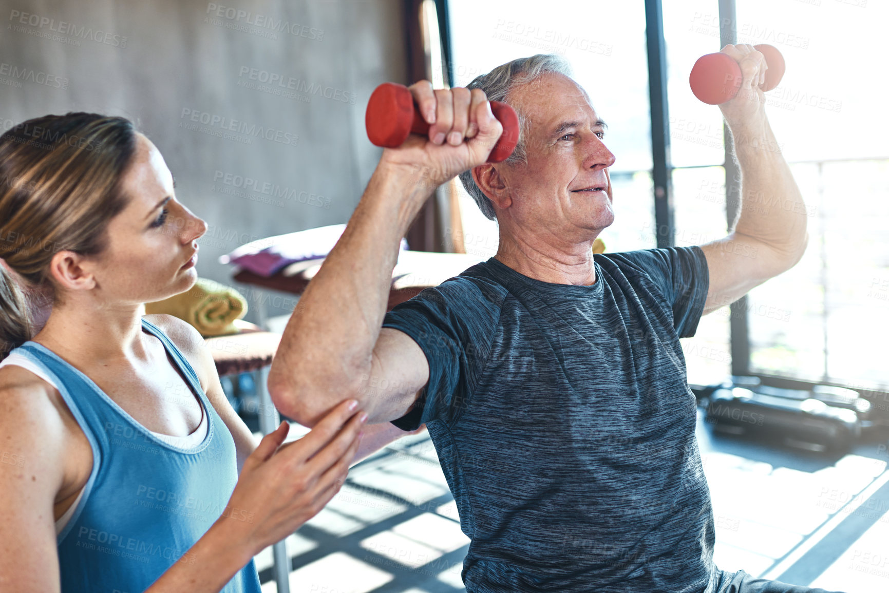 Buy stock photo Elderly man, physiotherapist and exercise with dumbbell in clinic for rehabilitation, support or recovery. Fitness, female coach and senior patient on ball for help, balance strength or physiotherapy