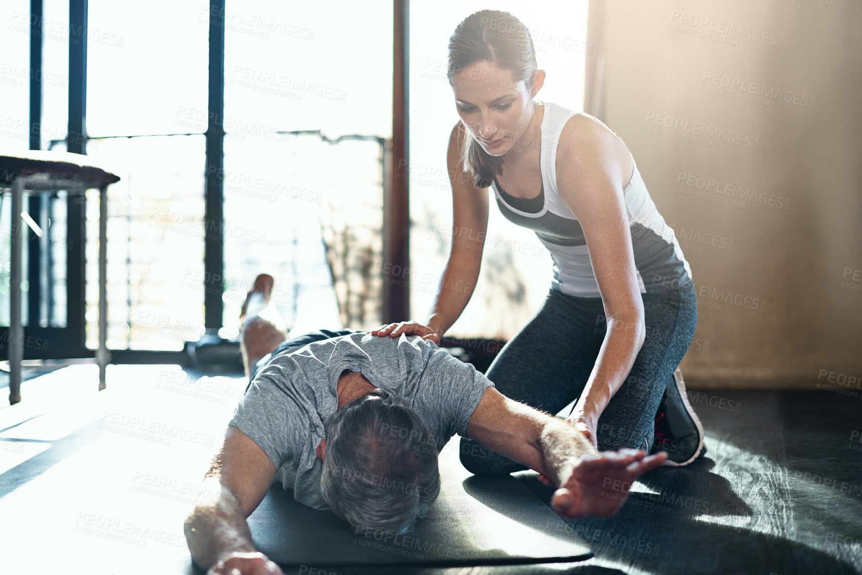 Buy stock photo Elderly person, stretching and physiotherapist in gym for health, wellness and exercise. Female coach, people and equipment in fitness centre for retirement, rehabilitation and physical therapy
