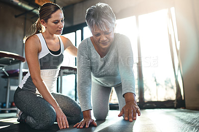 Buy stock photo Shot of a senior woman working out with her physiotherapist