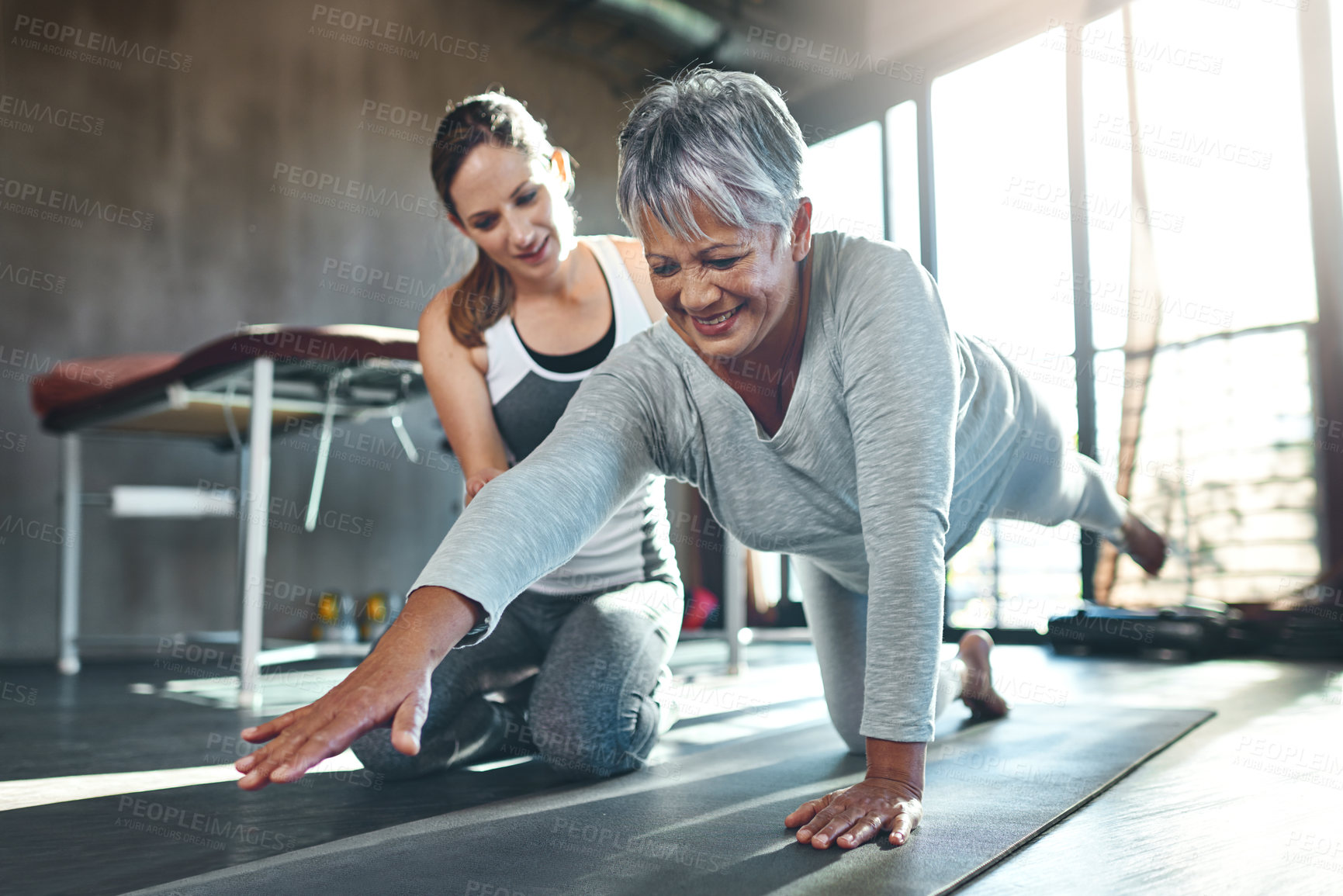 Buy stock photo Shot of a senior woman working out with her physiotherapist