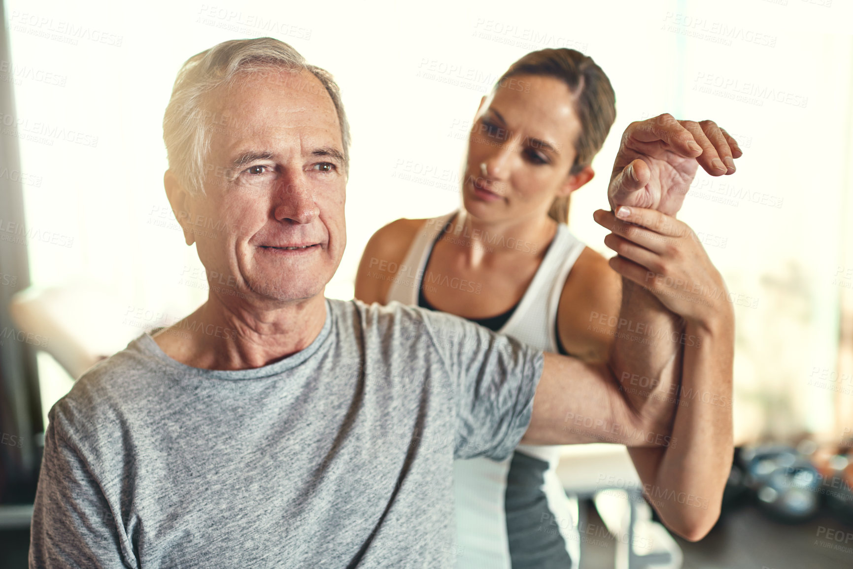 Buy stock photo Old man, physiotherapist and arm rehabilitation treatment or mobility exercise or flexibility, training or assessment. Patient, woman and healing therapy or injury results for muscle, wellness or job