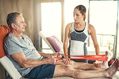 Buy stock photo Fitness, physiotherapist and senior man with resistance band in hospital for physiotherapy, support or stretching legs. Wellness, woman coach and elderly patient for help, training or rehabilitation