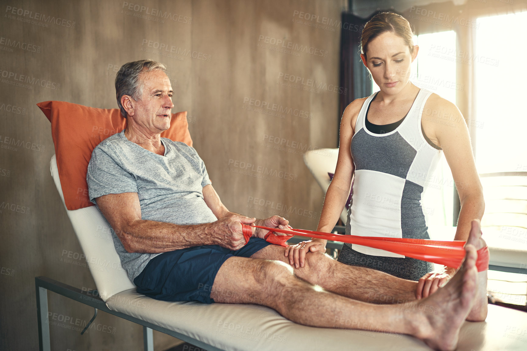 Buy stock photo Help, physiotherapist and senior man with resistance band in clinic for physiotherapy, support or stretching legs. Healthcare, woman coach and elderly patient for wellness, training or rehabilitation