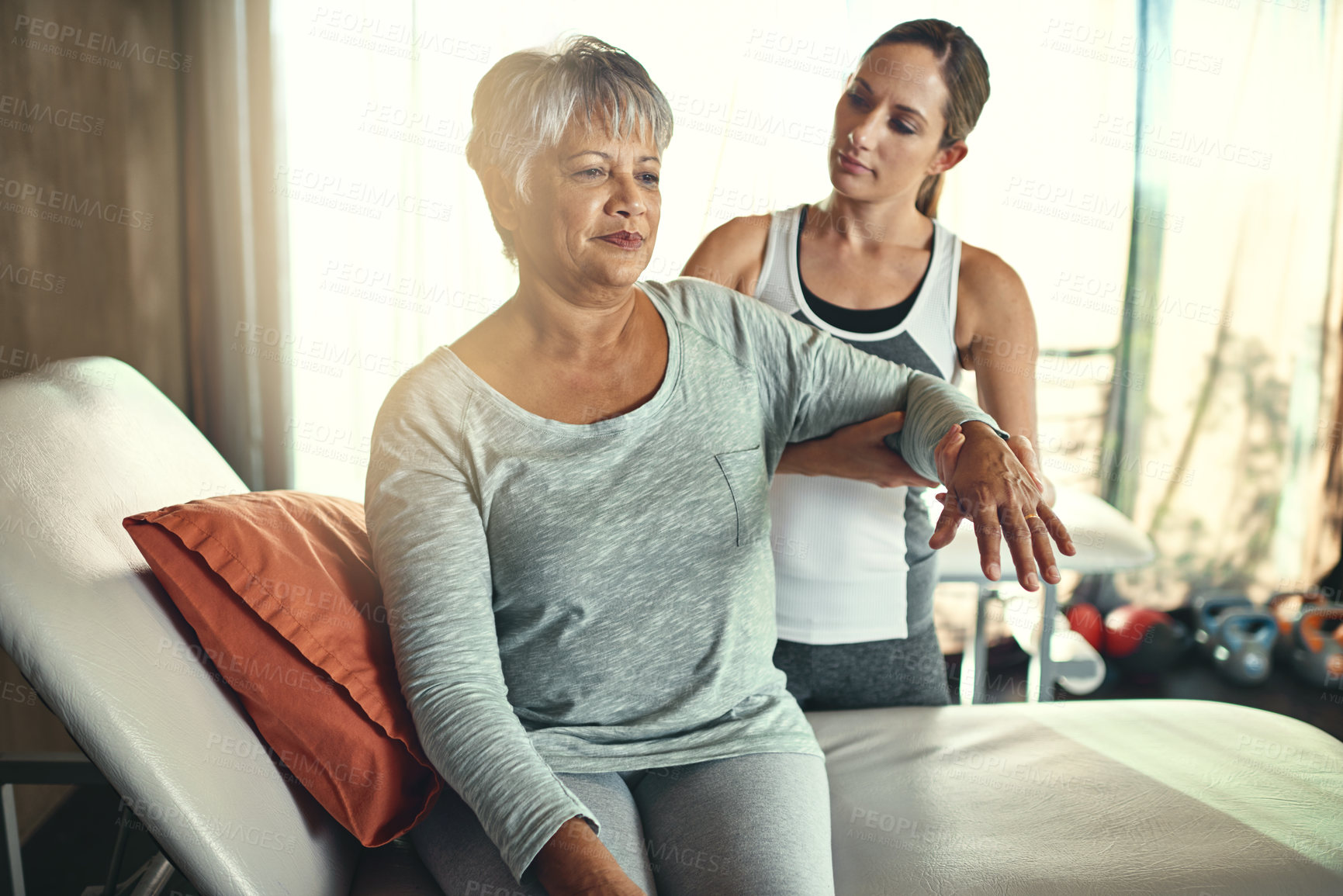 Buy stock photo Health, physiotherapy and senior woman with massage for muscle flexibility and injury recovery in clinic. Physical therapy, chiropractor and healthcare rehabilitation with support for osteoporosis