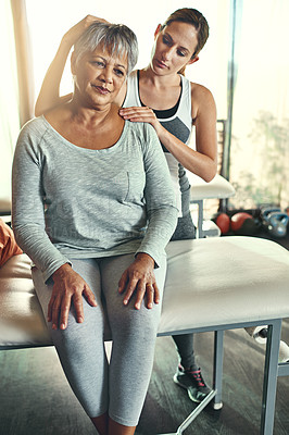 Buy stock photo Shot of a senior woman being treated by a physiotherapist