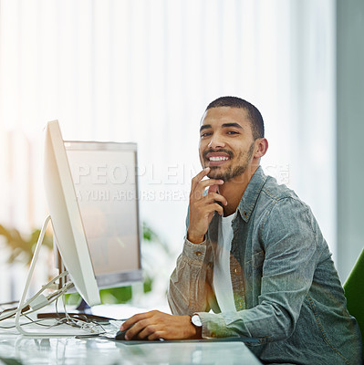 Buy stock photo Portrait of a smiling young designer working on a computer in a modern office