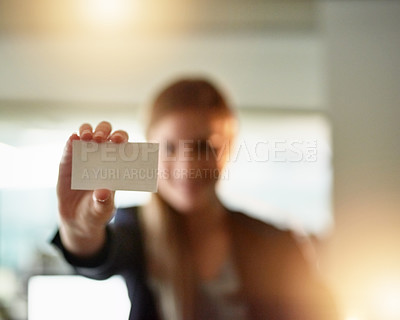 Buy stock photo Shot of a young businesswoman holding up a blank businesscard in the office