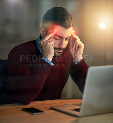 Buy stock photo Shot of a young designer battling a headache while working late in the office