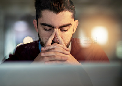 Buy stock photo Shot of a tired young designer working late in the office