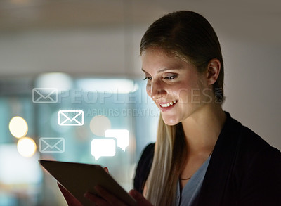 Buy stock photo Shot of a happy young designer using her tablet while working late in the office