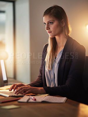Buy stock photo Shot of a focused young designer working late in the office