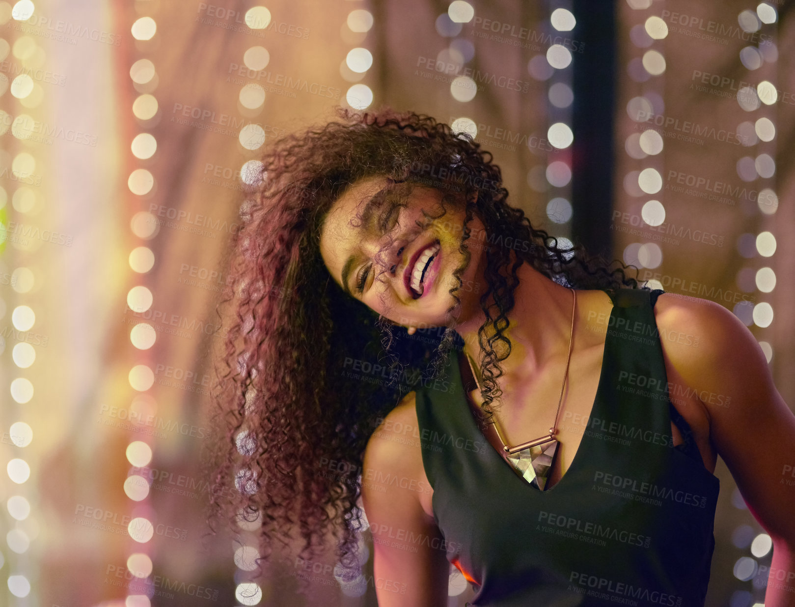 Buy stock photo Shot of a beautiful young woman dancing in a nightclub