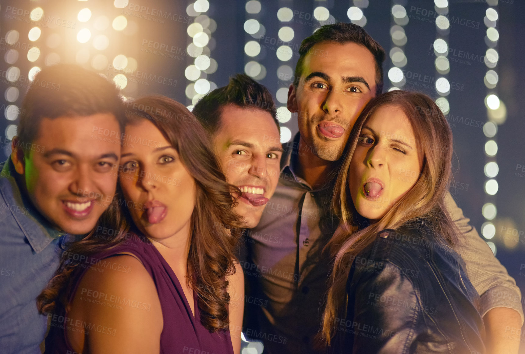 Buy stock photo Portrait of a group of friends having fun while out at a nightclub