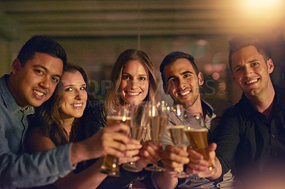 Buy stock photo Portrait of a group of people toasting with their drinks at a nightclub