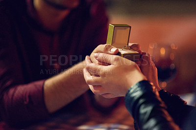 Buy stock photo Cropped shot of a man proposing to his girlfriend with an engagement ring in a box