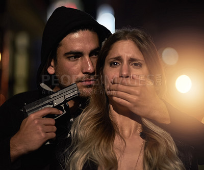 Buy stock photo Cropped shot of a young woman being held at gunpoint