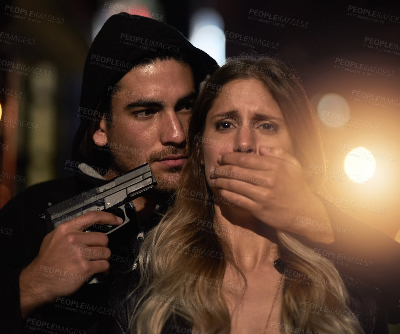 Buy stock photo Cropped shot of a young woman being held at gunpoint
