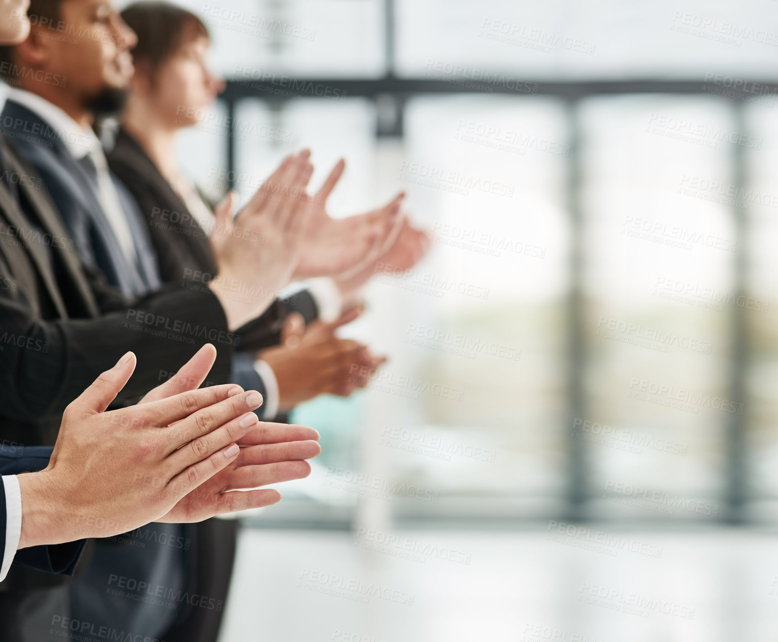 Buy stock photo Closeup shot of a group of executives clapping while standing in a row in an office