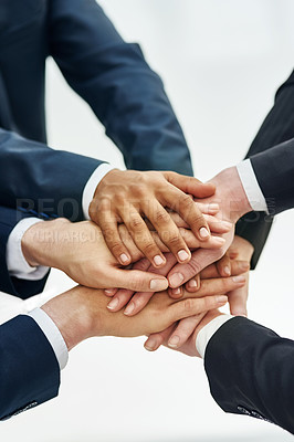 Buy stock photo Closeup shot of a group of businesspeople standing in a huddle with their hands stacked together