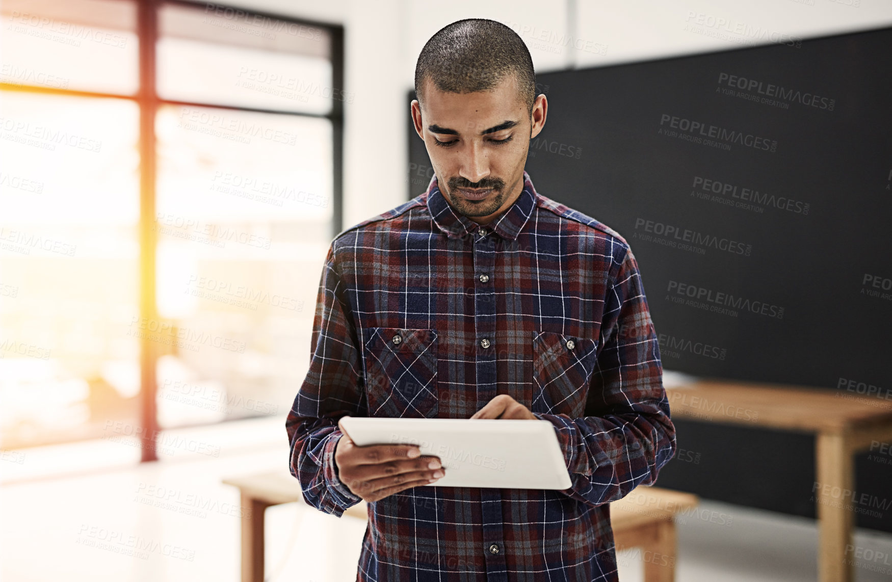 Buy stock photo Employee, man and serious at office with tablet for online reviews, research and insights as social media manager. Male person, business and internet or website for communication or networking