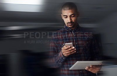 Buy stock photo Shot of a young entrepreneur texting on a cellphone in an office