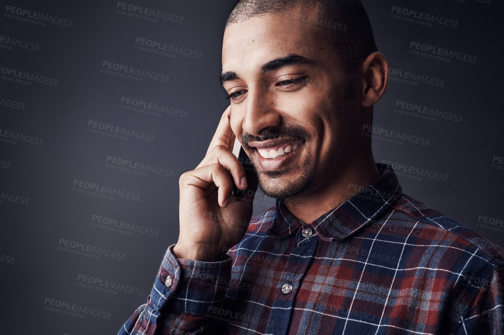 Buy stock photo Man, happy or phone call in studio for contact, good news or feedback for creative small business. Designer, entrepreneur or smile with tech for networking with conversation on black background space