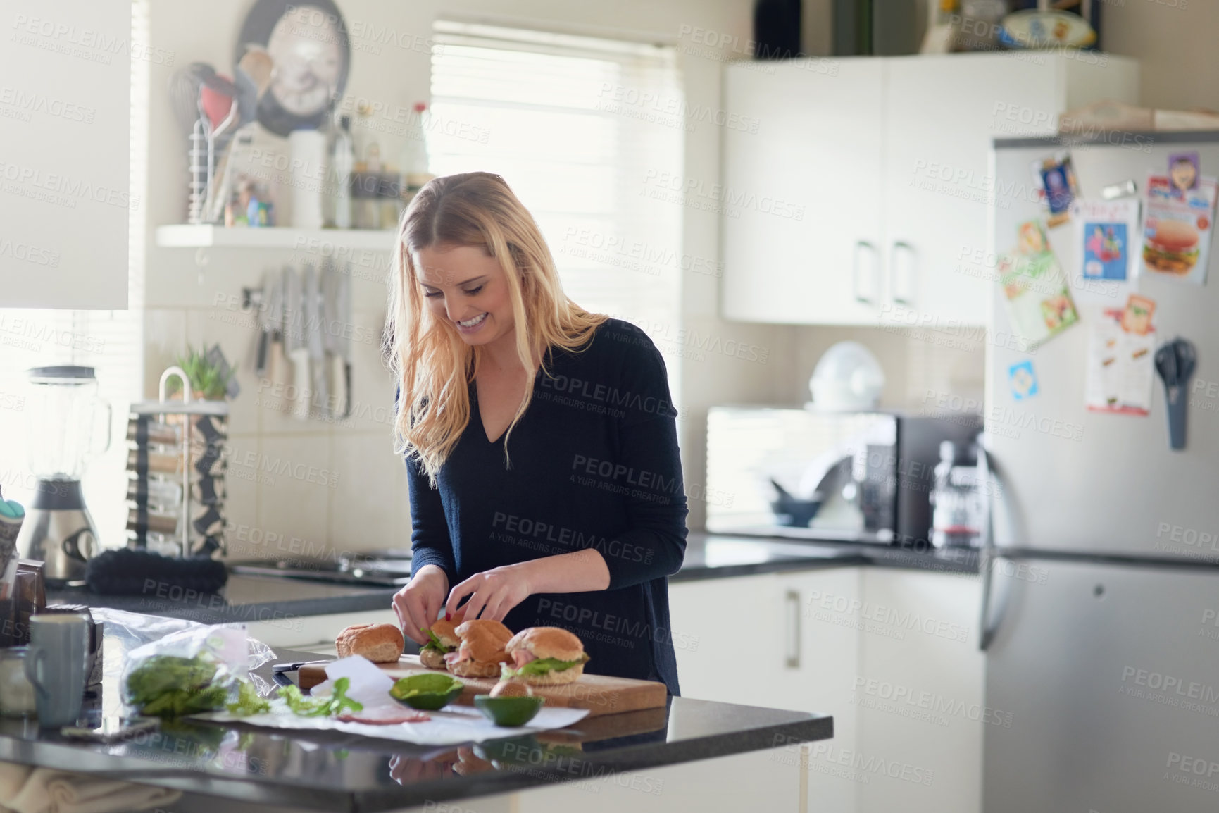 Buy stock photo Shot of an attractive young woman preparing a meal at home