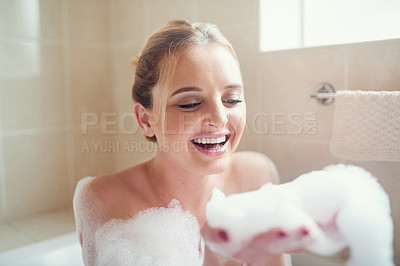 Buy stock photo Shot of an attractive young woman relaxing in the bathtub