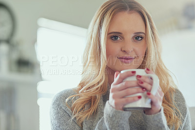 Buy stock photo Portrait of an attractive young woman enjoying a cup of coffee at home