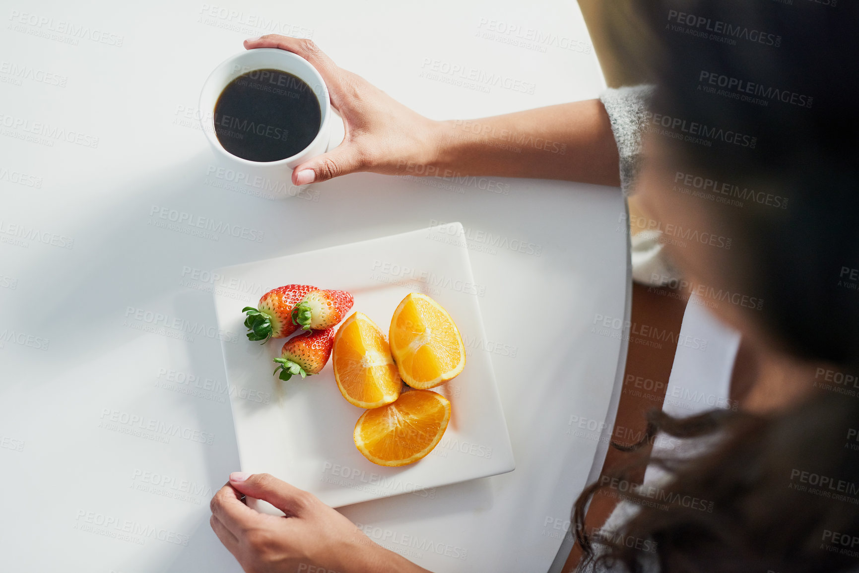 Buy stock photo Fruit, coffee and above person with breakfast in morning for benefits of nutrition in diet. Healthy, food and woman drink espresso on table in home eating strawberry and orange with vitamin c