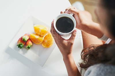 Buy stock photo Shot of an unidentifiable woman enjoying a healthy breakfast in her kitchen at home