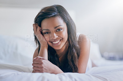 Buy stock photo Portrait of a happy young woman relaxing on her bed at home