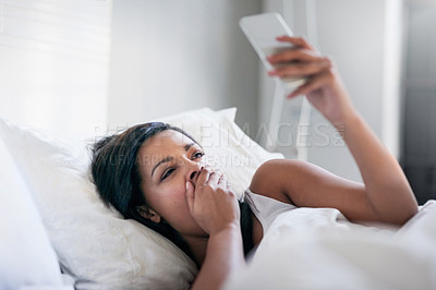 Buy stock photo Shot of sleepy young woman waking up in her bed at home