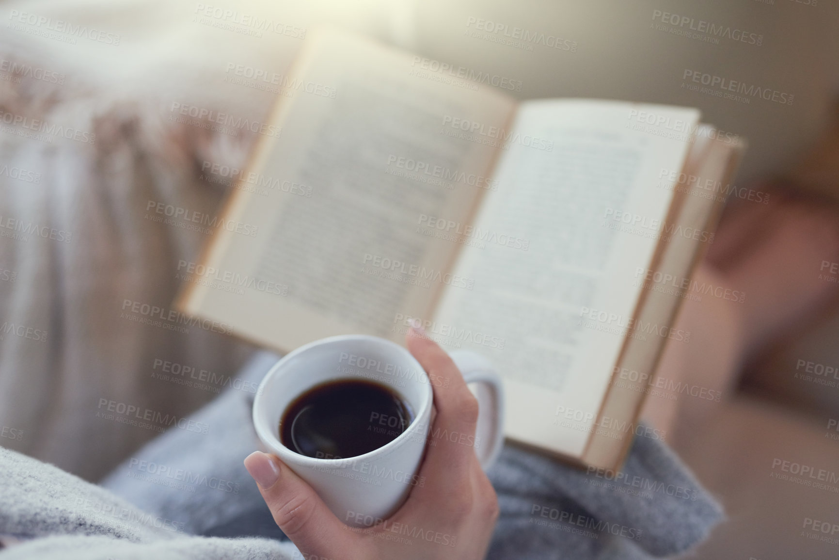 Buy stock photo Closeup shot of a woman relaxing with a book and cup of coffee