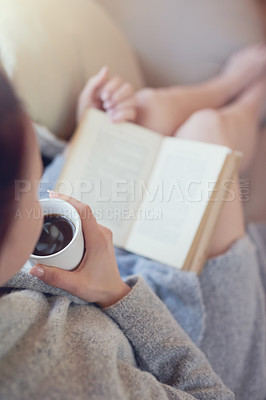 Buy stock photo Cropped shot of a woman relaxing with a book and cup of coffee at home