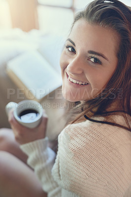 Buy stock photo Portrait of a beautiful young woman enjoying a cup of coffee at home