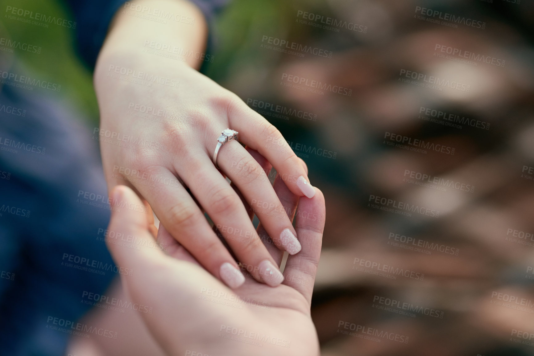 Buy stock photo Couple, engagement ring and nature with holding hands in closeup for proposal with love, surprise and commitment. Man, woman and vacation with jewelry, question and marriage offer in countryside