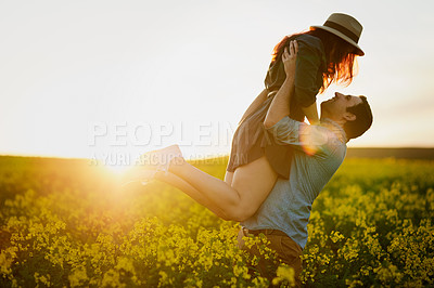 Buy stock photo Shot of an affectionate young couple enjoying a day outdoors together