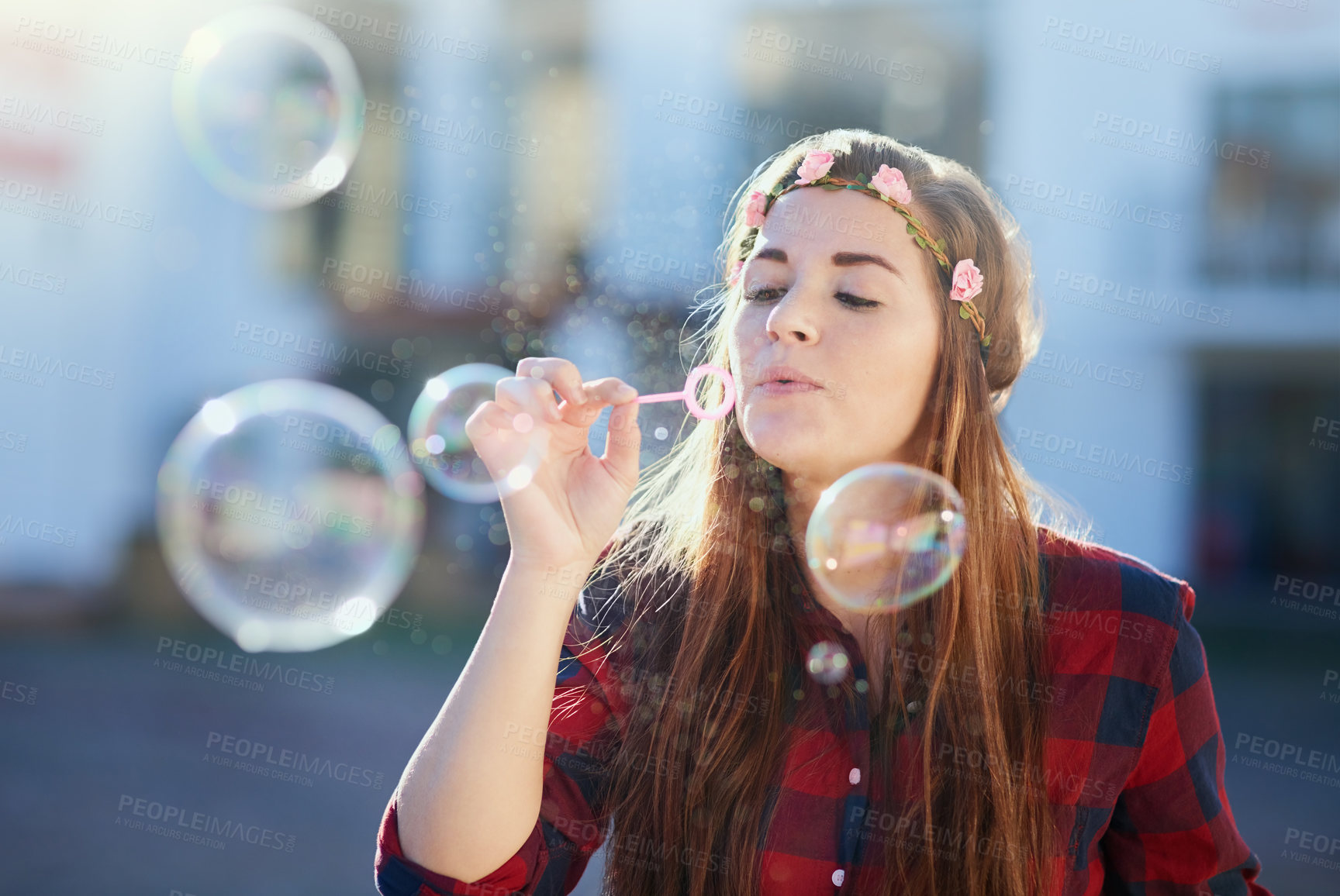 Buy stock photo Woman, play and blowing bubbles in street with fun in summer sunshine for memory with soap fluid. Girl, person and outdoor with liquid, celebration and magic with game on sidewalk in neighborhood