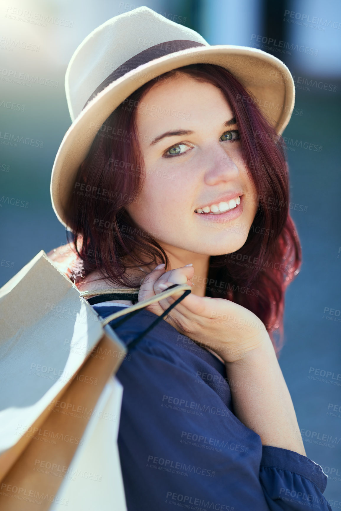 Buy stock photo Woman, shopping bag and happy in city for portrait with fashion, fedora or discount sale from mall. Girl, person and smile for package, clothes and outdoor on metro sidewalk with trendy hat in summer